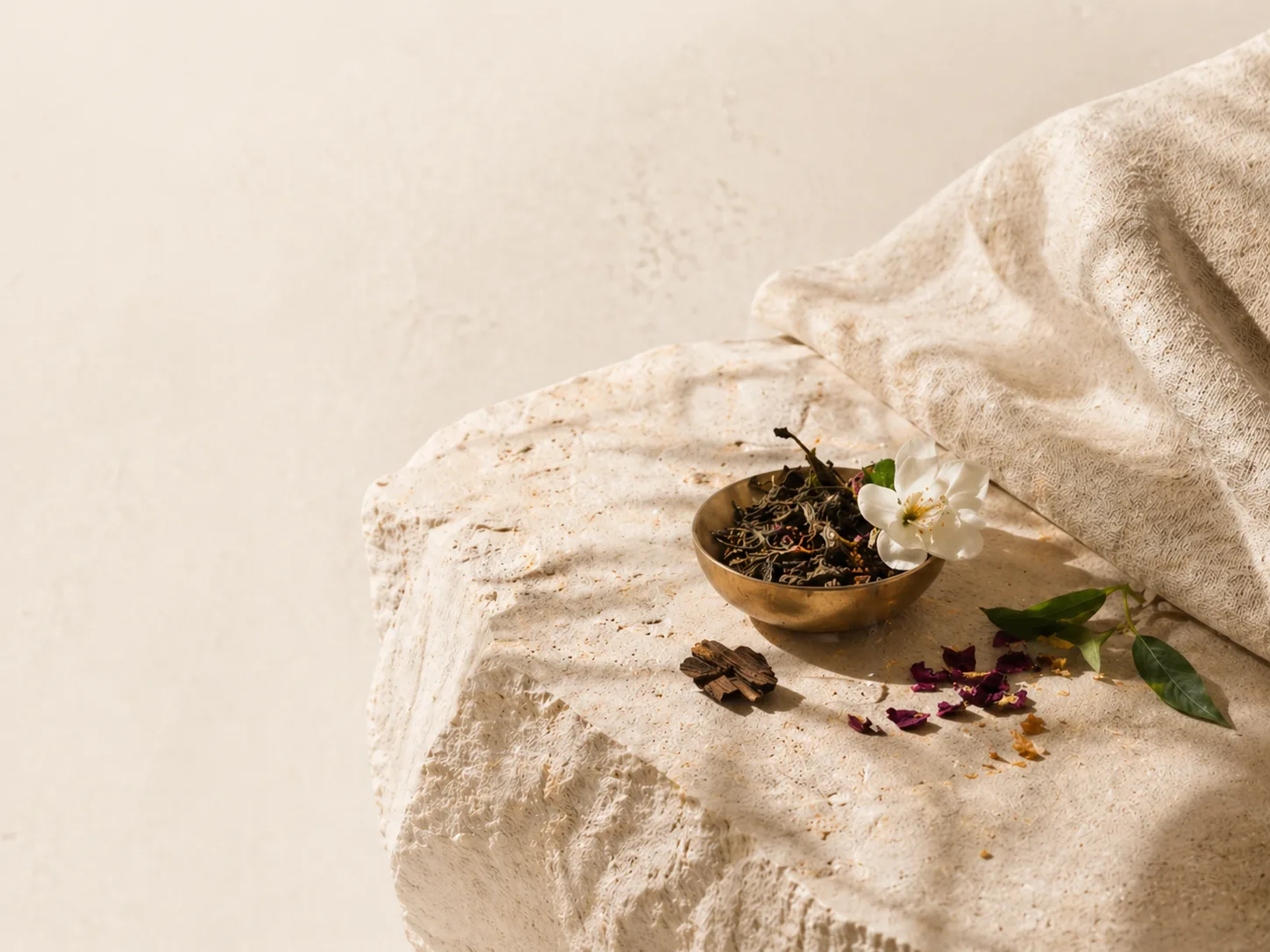 A Scentoria reed diffuser on a marble console in a hotel lobby, dried botanicals bleeding past the frame